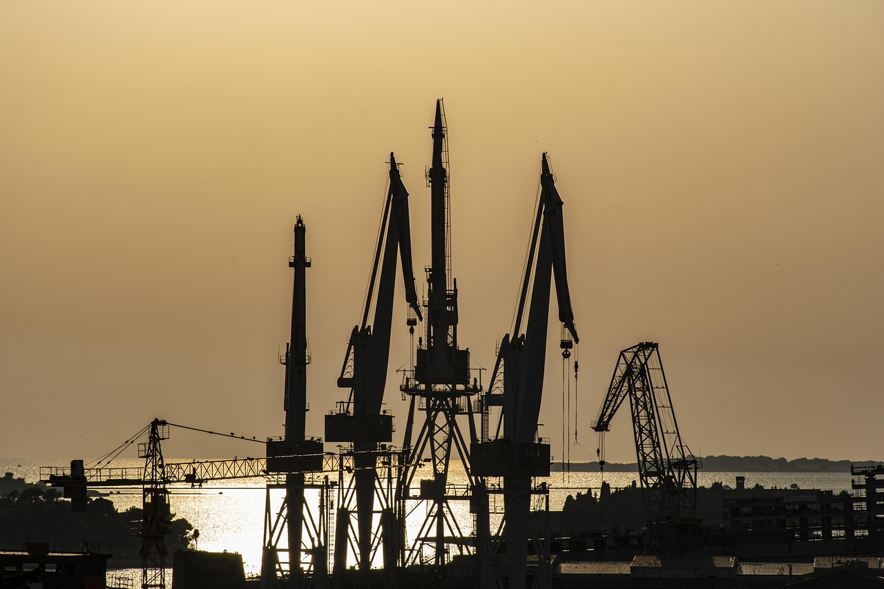 Pula shipyard cranes silhouetted at sunset